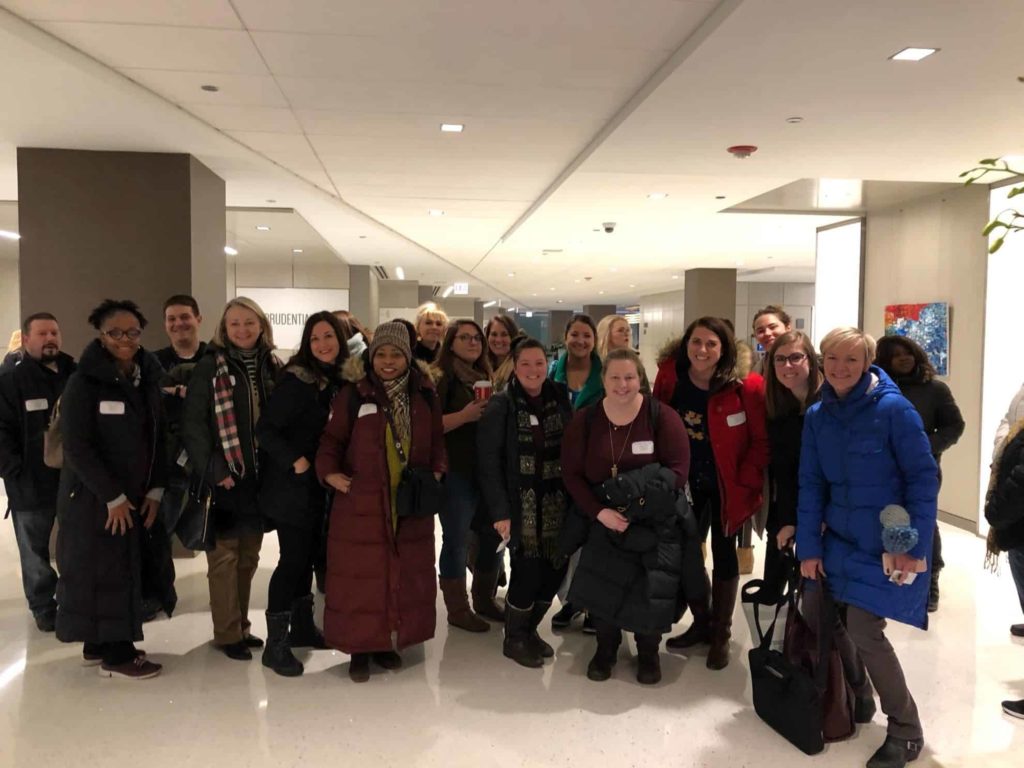 AAE staff pose for a photo in the lobby of our new building!